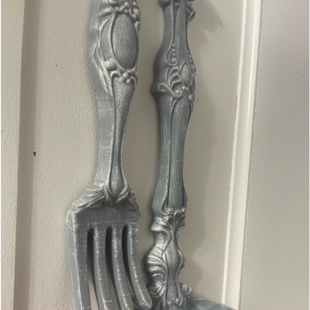 A pair of spoon and fork. Wall.  hanging cute for the kitchen.